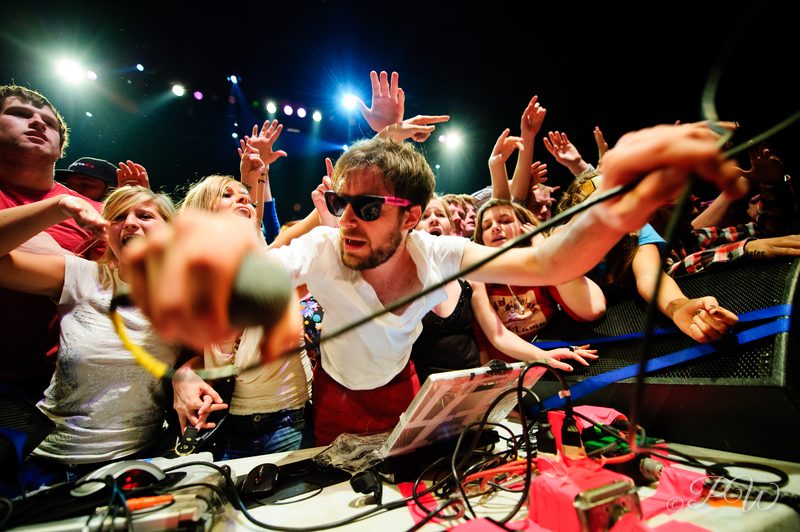 Fans crowd the stage around Girl Talk's DJ table at The Pageant