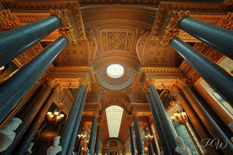 Looking up at gilded organ pipes and a painted ceiling