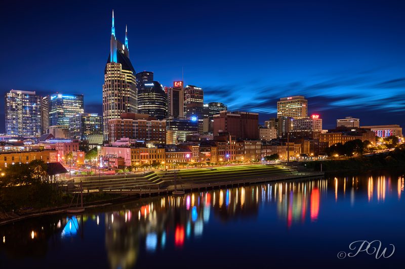 The Nashville skyline with the AT&T Building reflected in the Cumberland River at blue hour