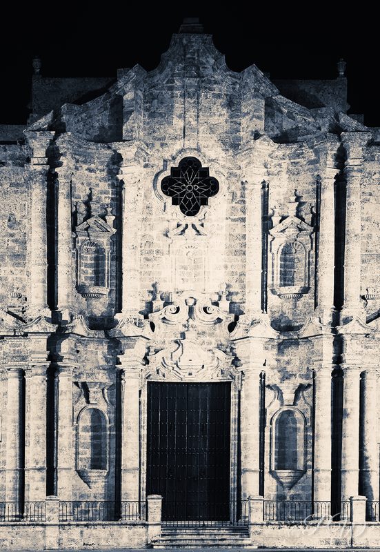 The carved baroque facade of the cathedral on Plaza de la Catedral, in high-key black and white