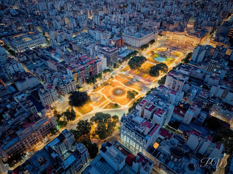 Aerial view of a lit plaza where diagonal avenues meet, Buenos Aires at dusk