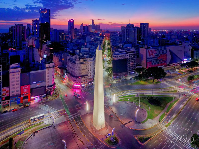Aerial view of the Obelisco and the lit traffic of Avenida 9 de Julio at dusk