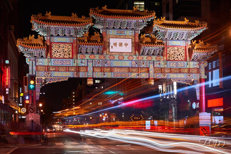 The Friendship Archway in Chinatown at night with light trails below