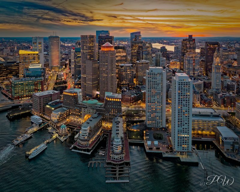 Aerial view of Boston towers and harbour piers in warm evening light